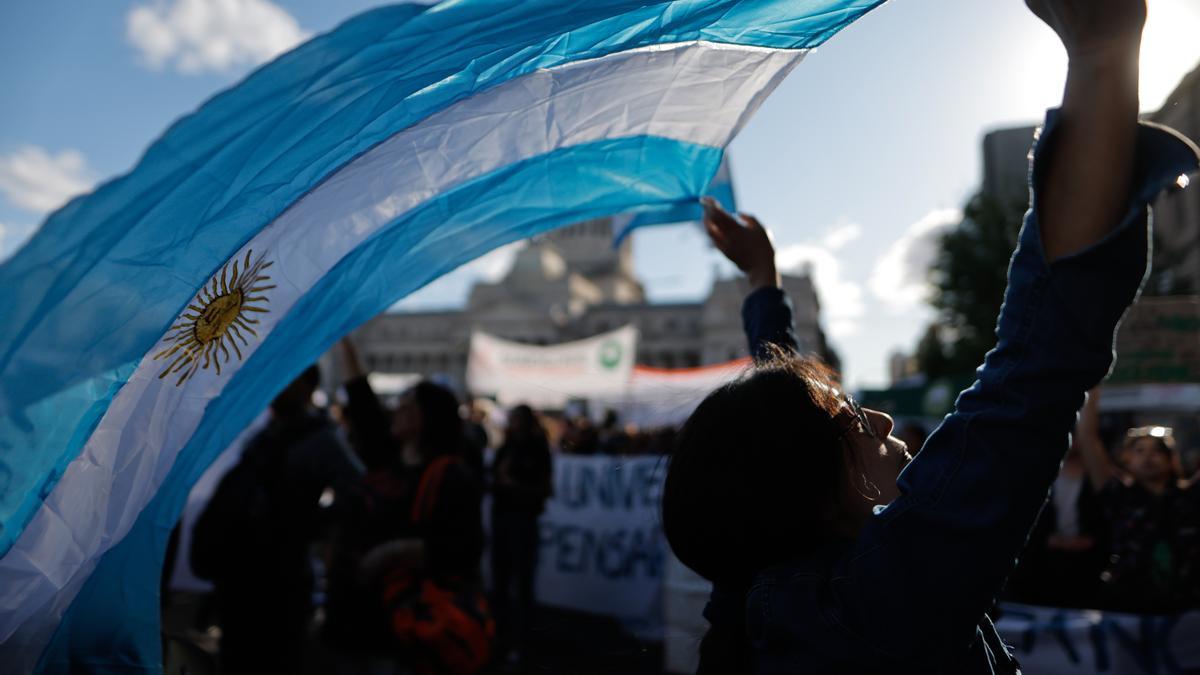 Una manifestante agita una bandera de Argentina en una marcha este miércoles, en Buenos Aires (Argentina).