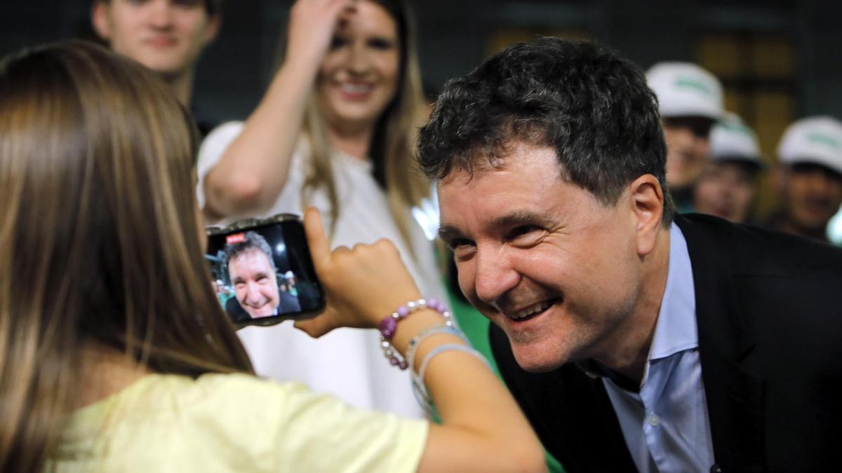 Nicusor Dan habla al móvil de una niña durante la noche de su victoria electoral tras ser reelegido como alcalde de Bucarest en 2024.